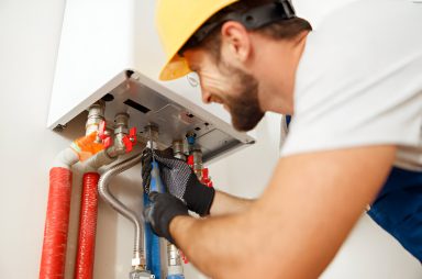 A plumber fixing a boiler